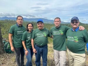 Team in green shirts at the planting site
